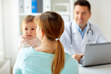 Image showing woman with baby and doctor with laptop at clinic