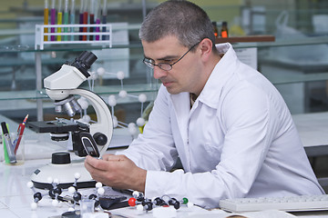 Image showing Researcher checking his mobile phone