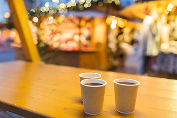 Image showing mulled wine in paper cups at christmas market