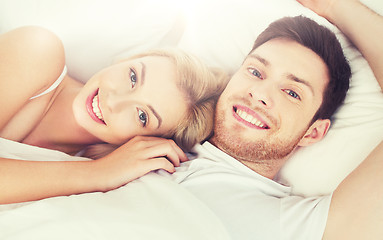 Image showing happy couple lying in bed at home