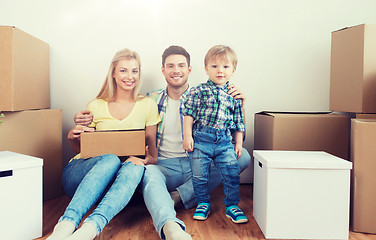 Image showing happy family with boxes moving to new home