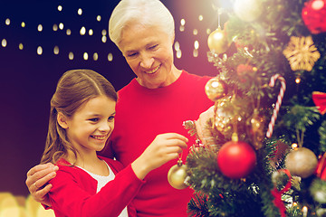 Image showing happy family decorating christmas tree