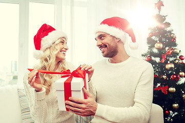 Image showing happy couple at home with christmas gift box