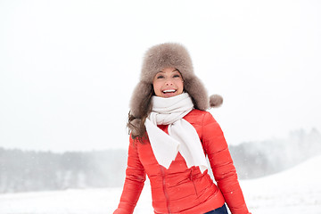 Image showing happy woman in winter fur hat outdoors