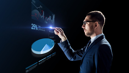 Image showing businessman working with virtual pie chart