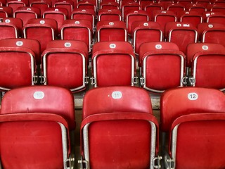 Image showing Empty red plastic seats in a stadium