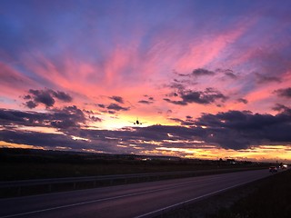 Image showing A plane is approaching Stuttgart AIrport during a dramatic sunset