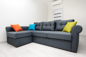 Image showing White living room with grey sofa