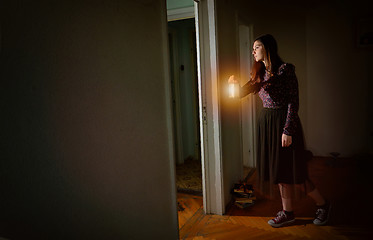 Image showing Young girl in black vintage dress with lantern