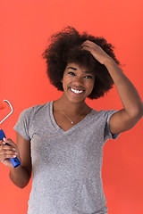 Image showing black woman painting wall