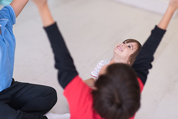 Image showing young boys having fun on the floor