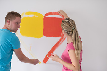 Image showing couple are painting a heart on the wall