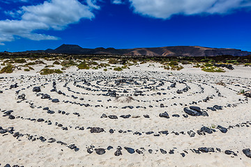 Image showing A round stone pattern in the sand by a beach on Lanzarote.