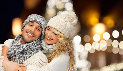 Image showing happy couple hugging over christmas lights