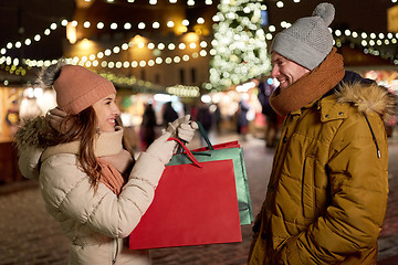 Image showing happy couple at with shopping bags in winter