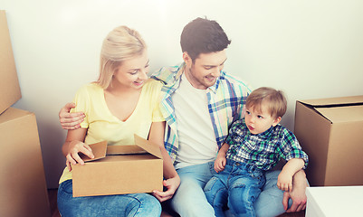 Image showing happy family with boxes moving to new home