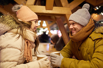 Image showing happy young couple with coffee at christmas market