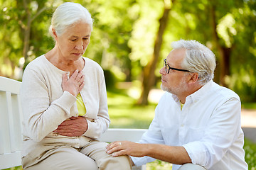 Image showing senior woman feeling sick at summer park