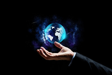Image showing close up of businessman hand with earth projection