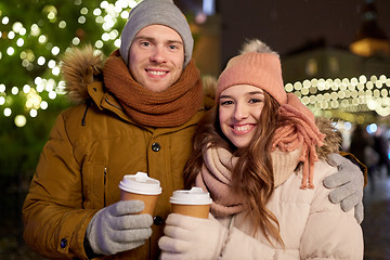 Image showing happy young couple with coffee at christmas market