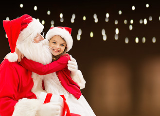 Image showing santa claus with christmas gift and happy girl