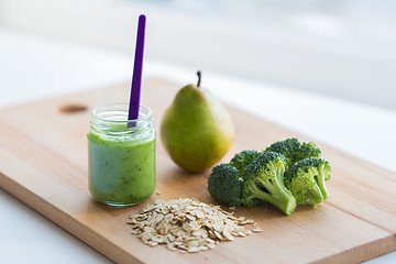 Image showing jar with puree or baby food on wooden board