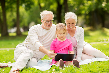 Image showing grandparents and granddaughter with tablet pc