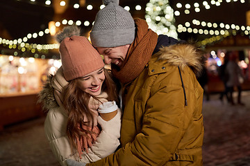 Image showing happy young couple with coffee at christmas market