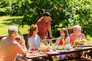 Image showing happy family having dinner or summer garden party