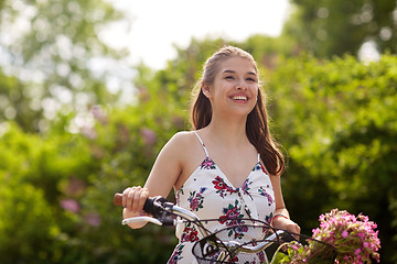 Image showing happy woman riding fixie bicycle in summer park