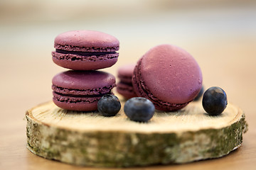 Image showing blueberry macarons on wooden stand