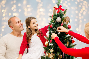 Image showing mother, father and daughter at christmas tree