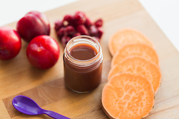 Image showing fruit puree or baby food in jar and feeding spoon