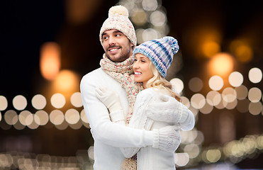 Image showing happy couple hugging over christmas lights