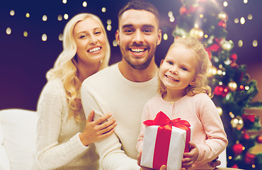 Image showing happy family at home with christmas gift box