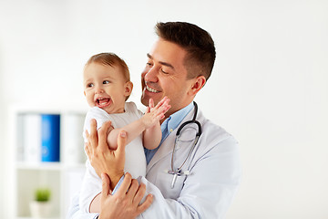 Image showing happy doctor or pediatrician with baby at clinic