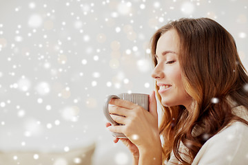 Image showing happy woman with cup of tea or coffee at home