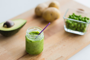 Image showing jar with puree or baby food on wooden board