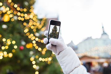 Image showing hands with smartphone photographing christmas tree