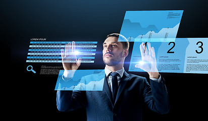 Image showing businessman with stock charts on virtual screens