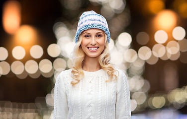 Image showing happy woman over christmas lights