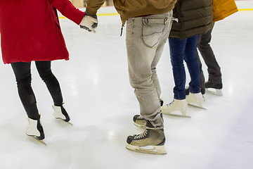 Image showing close up of friends on skating rink