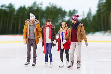 Image showing friends holding hands on outdoor skating rink