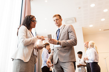 Image showing couple with smartphone at business conference