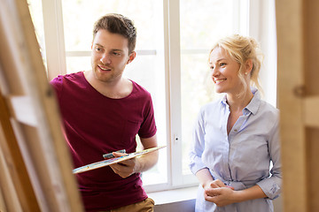 Image showing artists with palette and easel at art school