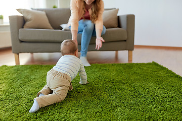 Image showing happy young mother playing with baby at home