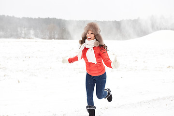 Image showing happy woman in winter fur hat having fun outdoors