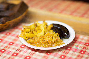 Image showing braised cabbage and sausages with sauce on plate