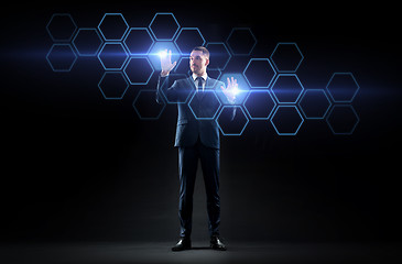 Image showing businessman working with virtual network hologram