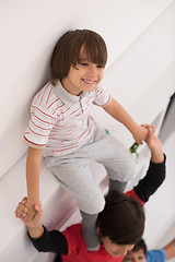 Image showing young boys posing line up piggyback top view